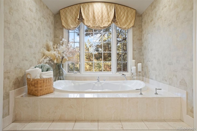 bathroom featuring a relaxing tiled tub, tile patterned floors, and plenty of natural light