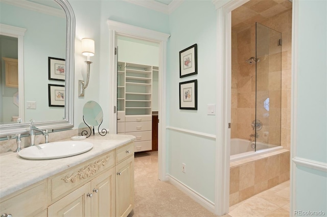 bathroom with vanity, crown molding, and tiled shower / bath combo