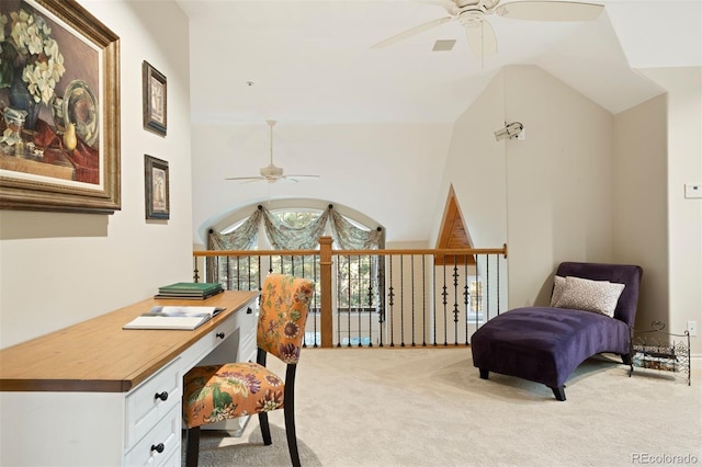 office space with built in desk, light colored carpet, high vaulted ceiling, and ceiling fan