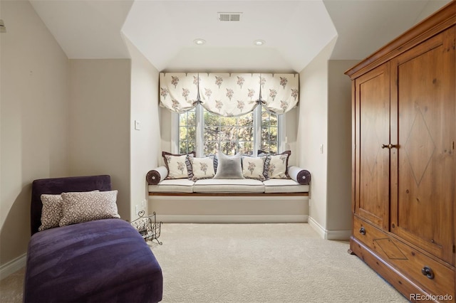 sitting room featuring light carpet and lofted ceiling