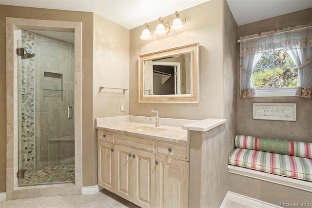 bathroom with vanity and a shower with shower door