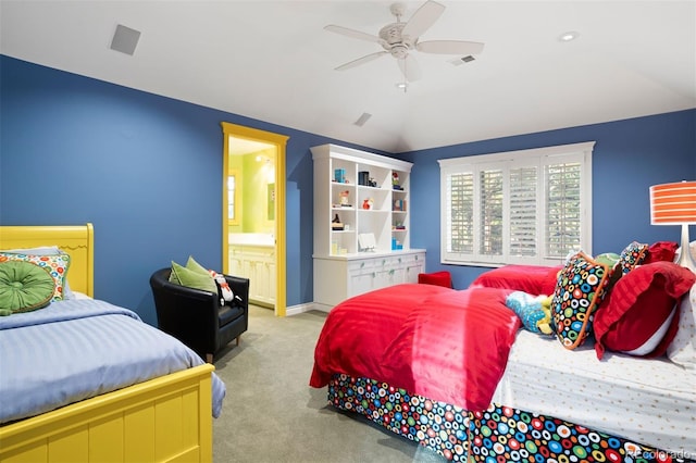 carpeted bedroom with connected bathroom, vaulted ceiling, and ceiling fan