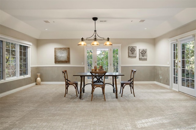 carpeted dining area with plenty of natural light