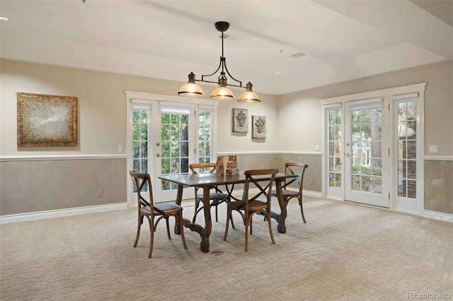 dining area with light colored carpet and plenty of natural light