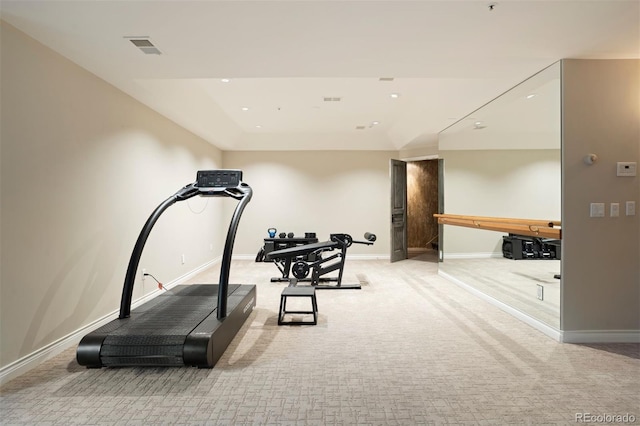 exercise room with light colored carpet