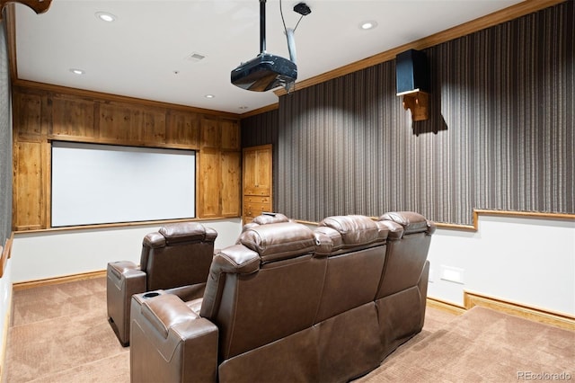 carpeted home theater room with crown molding