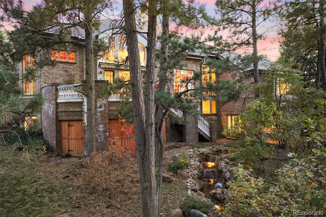 view of back house at dusk