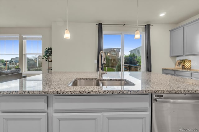 4884 St Vrain Rd, Firestone, CO 80504 - kitchen with dishwasher, a sink, plenty of natural light, light stone countertops, and recessed lighting