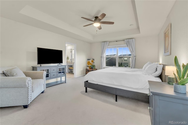 4884 St Vrain Rd, Firestone, CO 80504 - bedroom featuring a tray ceiling, light carpet, a ceiling fan, and baseboards