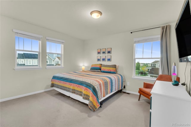4884 St Vrain Rd, Firestone, CO 80504 - bedroom with multiple windows, light carpet, and baseboards