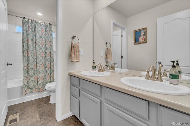 4884 St Vrain Rd, Firestone, CO 80504 - bathroom with double vanity, shower / bath combo, toilet, and baseboards