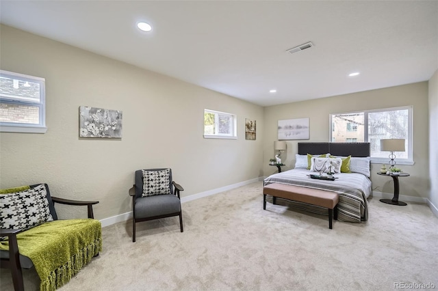 carpeted bedroom featuring baseboards, multiple windows, and visible vents