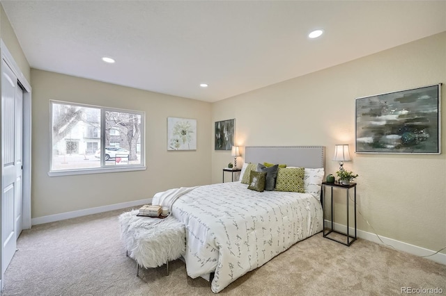 carpeted bedroom with a closet, recessed lighting, and baseboards