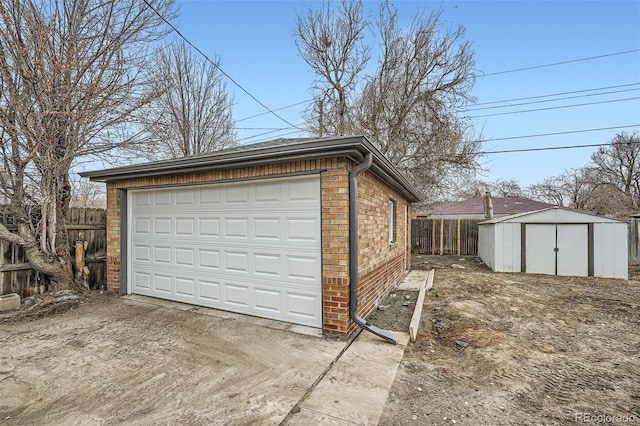 detached garage featuring fence