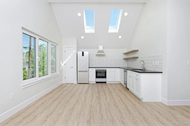 kitchen featuring backsplash, wall oven, high vaulted ceiling, and white fridge