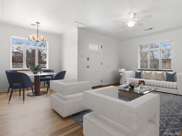 living room with a notable chandelier and hardwood / wood-style floors