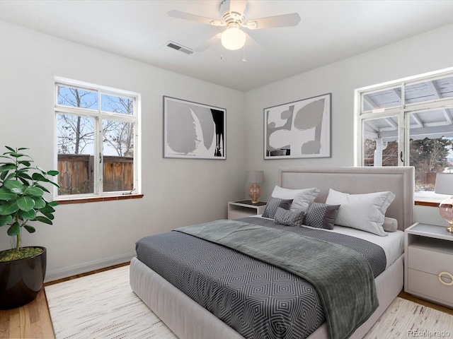 bedroom with light wood-type flooring and ceiling fan