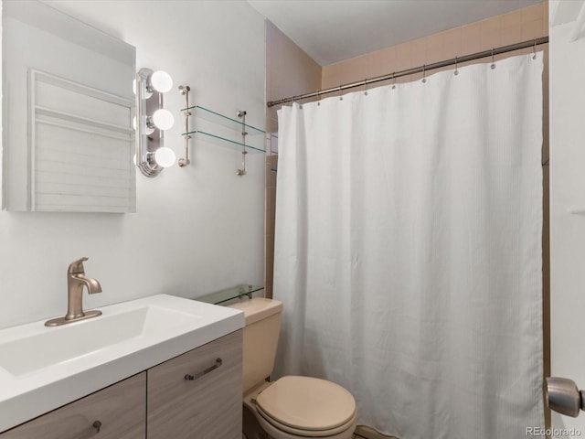 bathroom featuring curtained shower, toilet, and vanity