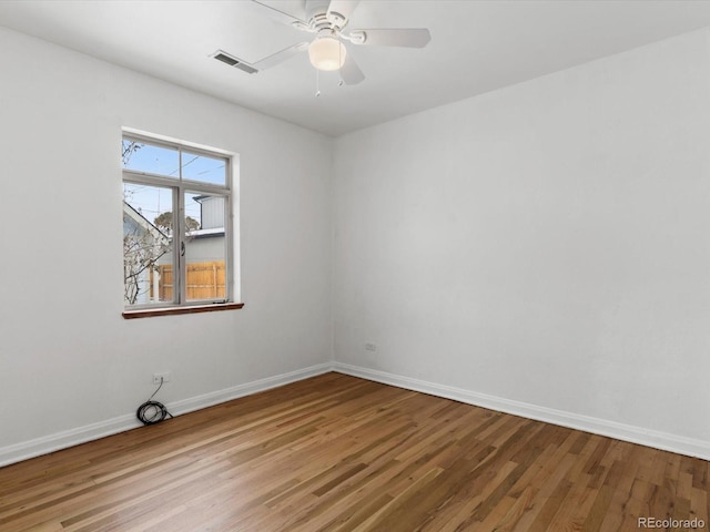 spare room with ceiling fan and wood-type flooring