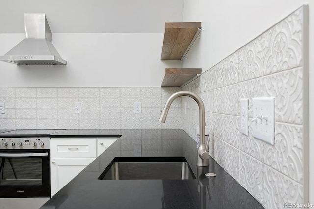 kitchen featuring sink, white cabinets, cooktop, wall oven, and ventilation hood