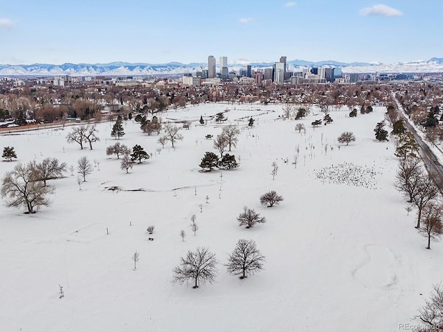 snowy aerial view with a mountain view