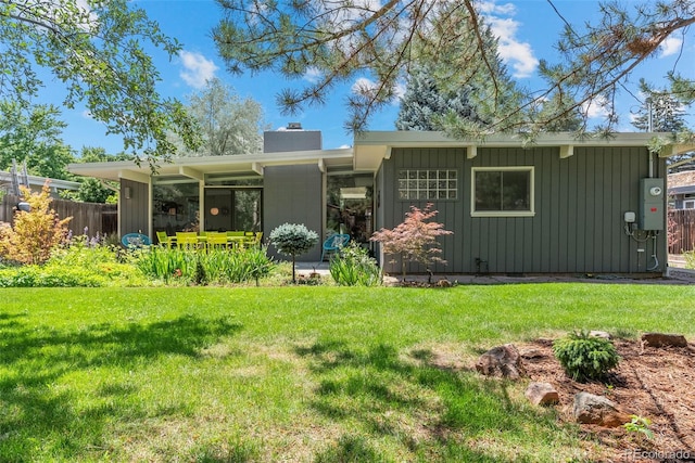 1338 S Fairfax St, Denver, CO 80222 - rear view of house featuring a chimney and board and batten siding