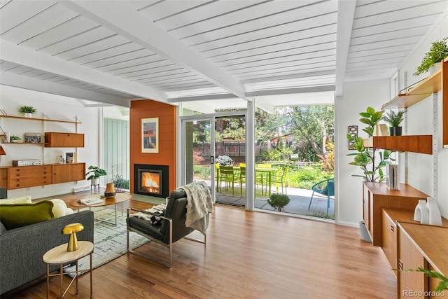 1338 S Fairfax St, Denver, CO 80222 - living room with light wood finished floors, floor to ceiling windows, a fireplace, and a wooden ceiling with exposed beams