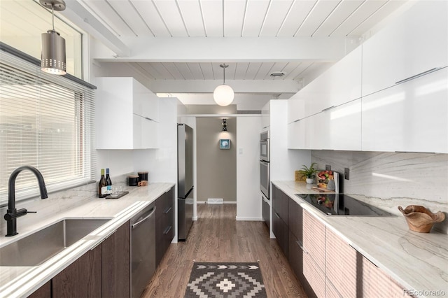 1338 S Fairfax St, Denver, CO 80222 - kitchen with stainless steel appliances, modern cabinets, white cabinetry, and a wooden ceiling with exposed beams