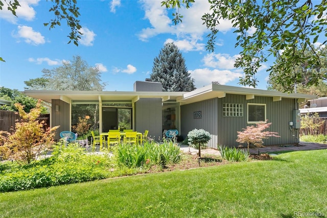 1338 S Fairfax St, Denver, CO 80222 - back of property featuring a chimney and a patio