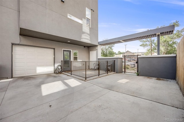 2922 W 26th Ave Unit 1, Denver, CO 80211 - view of patio / terrace featuring a gate, an attached garage, and driveway