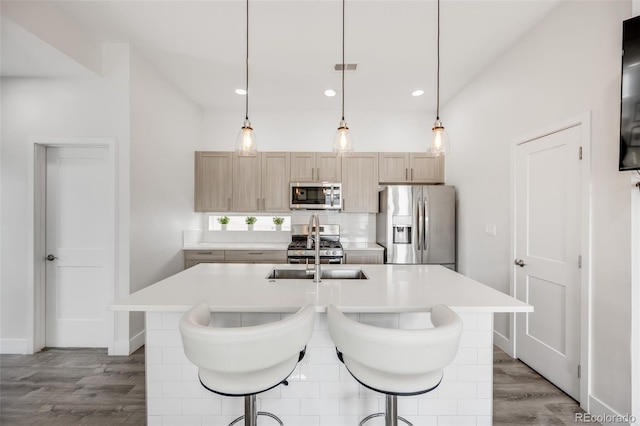 2922 W 26th Ave Unit 1, Denver, CO 80211 - kitchen with stainless steel appliances, decorative backsplash, light countertops, light wood-style flooring, and recessed lighting