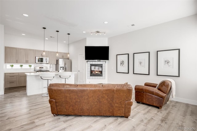 2922 W 26th Ave Unit 1, Denver, CO 80211 - living area with light wood-style floors, recessed lighting, and a tile fireplace