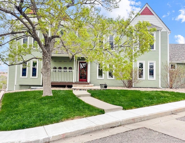 view of front of home with a front yard and covered porch