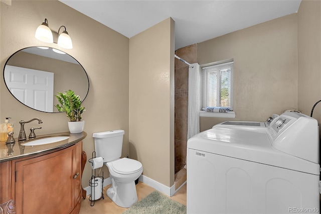 bathroom featuring toilet, vanity, washer and clothes dryer, and a shower with shower curtain