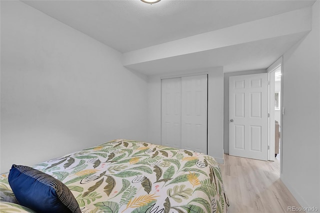 bedroom featuring light wood-type flooring and a closet