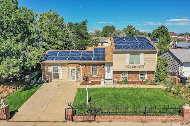 view of front of home with solar panels and a front yard