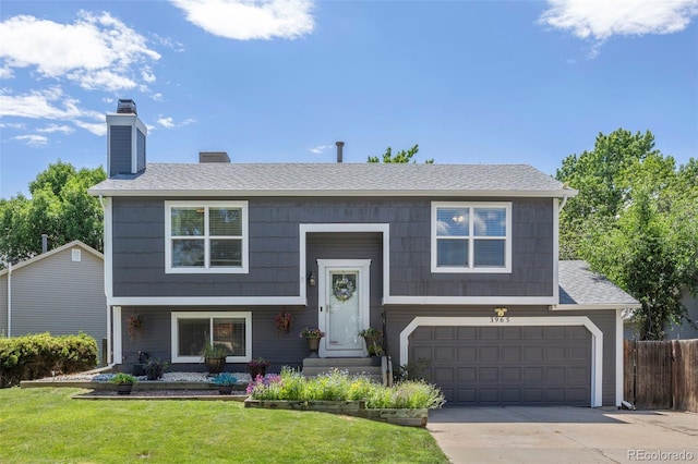 3965 S Fundy Cir, Aurora, CO 80013 - bi-level home with an attached garage, a chimney, concrete driveway, and roof with shingles