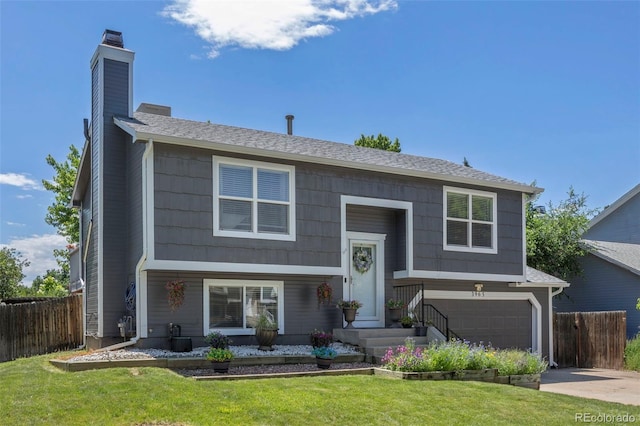 3965 S Fundy Cir, Aurora, CO 80013 - bi-level home with a garage, a chimney, and concrete driveway