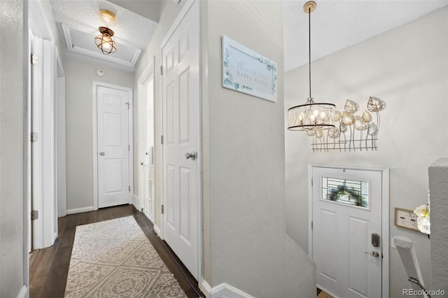 3965 S Fundy Cir, Aurora, CO 80013 - entrance foyer with dark wood-style flooring, a chandelier, a textured wall, and a textured ceiling