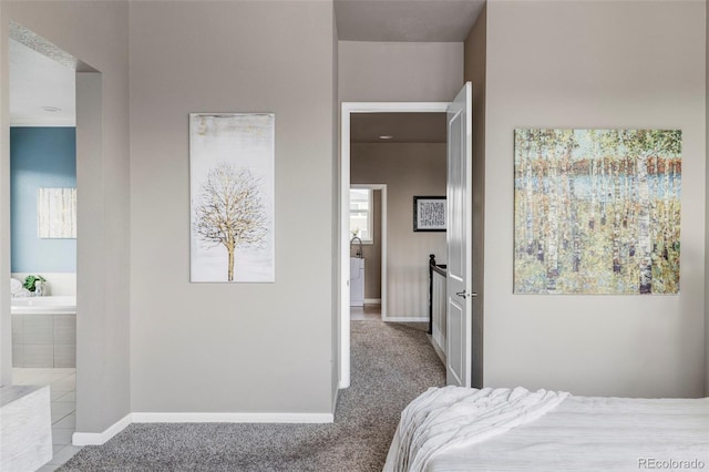 bedroom featuring light colored carpet and connected bathroom