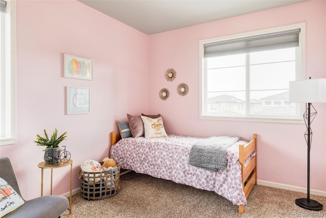 bedroom featuring multiple windows and carpet flooring