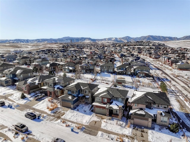 snowy aerial view featuring a mountain view