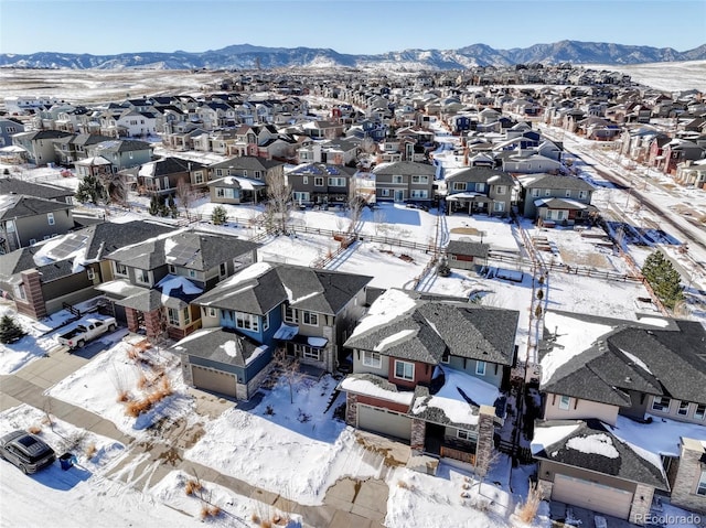 snowy aerial view with a mountain view