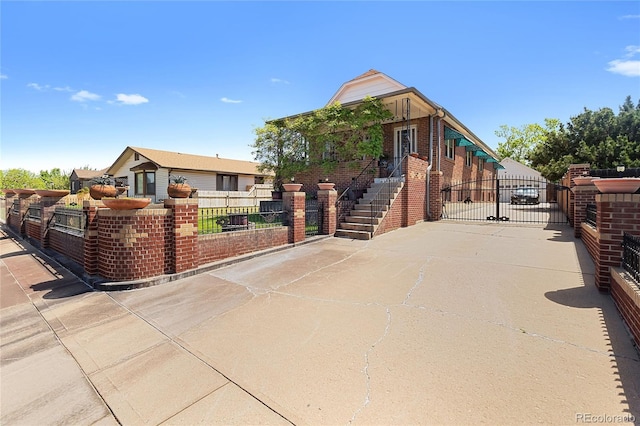 5960 Glencoe St, Commerce City, CO 80022 - view of front facade with a gate and brick siding