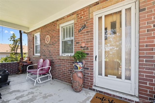5960 Glencoe St, Commerce City, CO 80022 - property entrance with brick siding and a porch