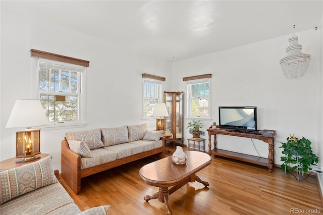 5960 Glencoe St, Commerce City, CO 80022 - living room featuring healthy amount of natural light and wood finished floors