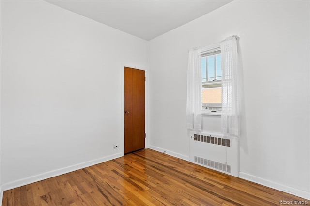 5960 Glencoe St, Commerce City, CO 80022 - unfurnished room featuring radiator, wood finished floors, and baseboards