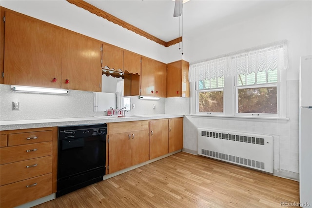 5960 Glencoe St, Commerce City, CO 80022 - kitchen with radiator heating unit, dishwasher, a sink, light wood-type flooring, and light countertops