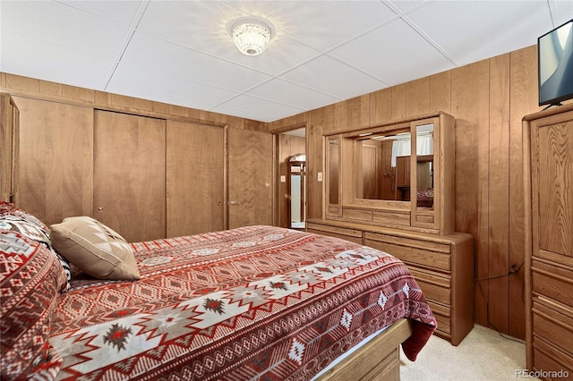 5960 Glencoe St, Commerce City, CO 80022 - bedroom with wood walls, light colored carpet, and a closet