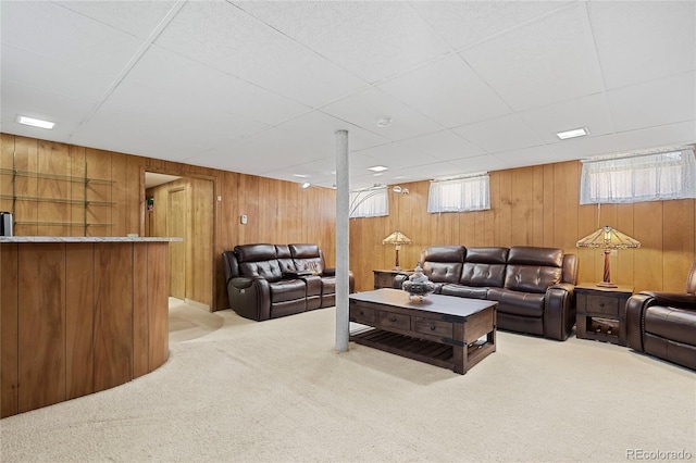 5960 Glencoe St, Commerce City, CO 80022 - living room with carpet flooring, wooden walls, a drop ceiling, and a bar